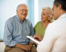 senior couple speaking to physician 