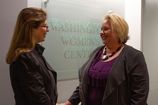 Two women shaking hands