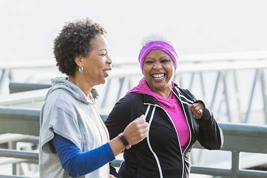 Two women walking and talking with each other 