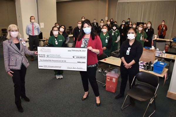 A group holding a large check