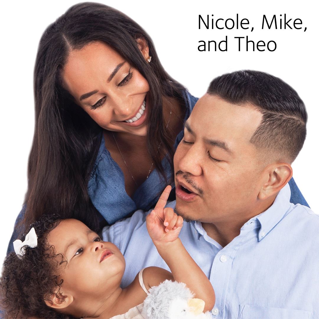 little girl pointing at her parents