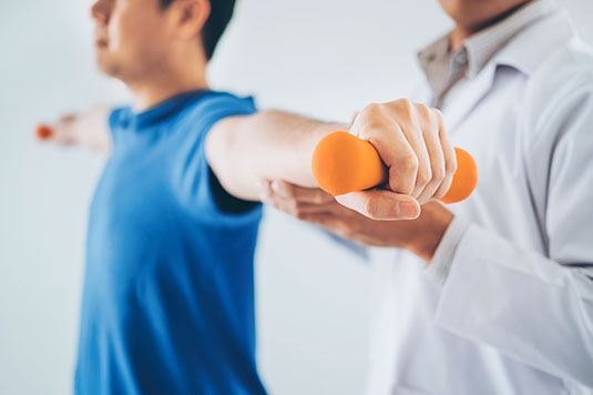 A person holding hand weights straight out